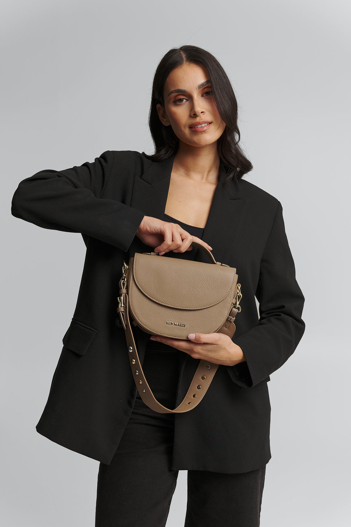 Tragebild mit Model auf neutralem Hintergrund des Produktes Urban Stud Strap in der Farbe Mocha