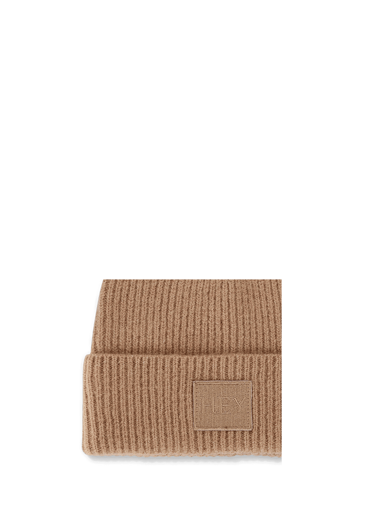 Seitenansicht auf neutralem Hintergrund des Produktes Hey Beanie in der Farbe Sand