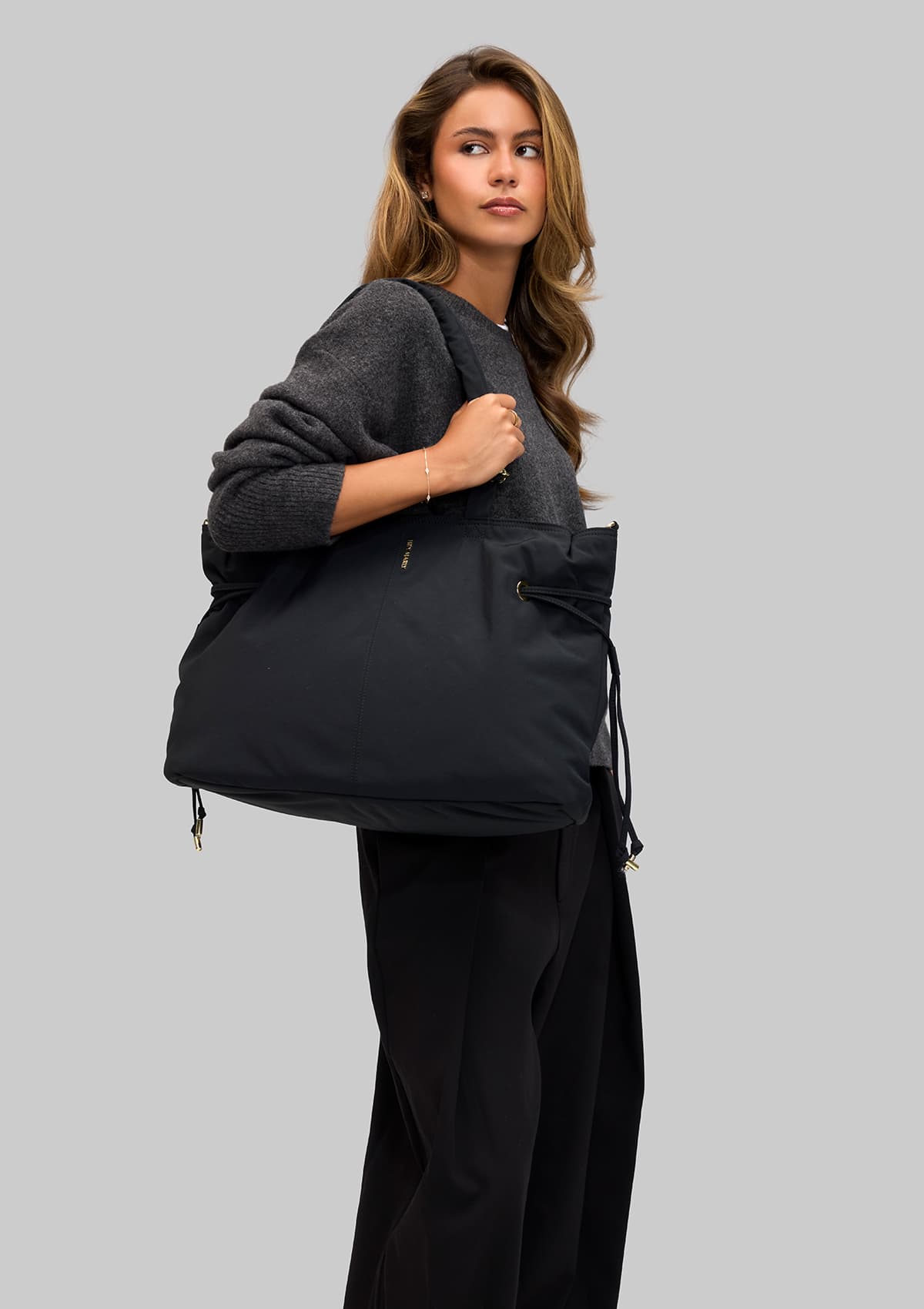 Tragebild mit Model auf neutralem Hintergrund des Produktes Easy Companion L in der Farbe Black in der Größe L