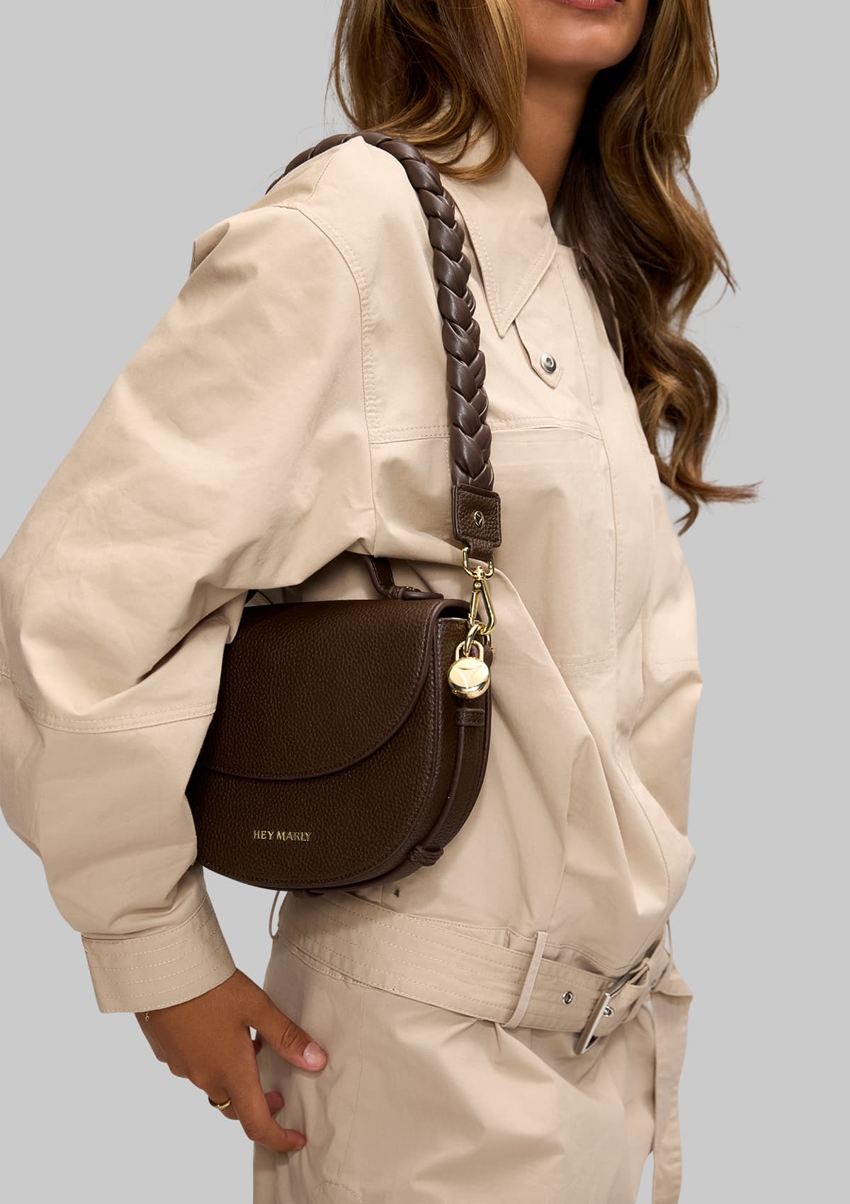 Tragebild mit Model auf neutralem Hintergrund des Produktes Braided Strap in der Farbe Coffee